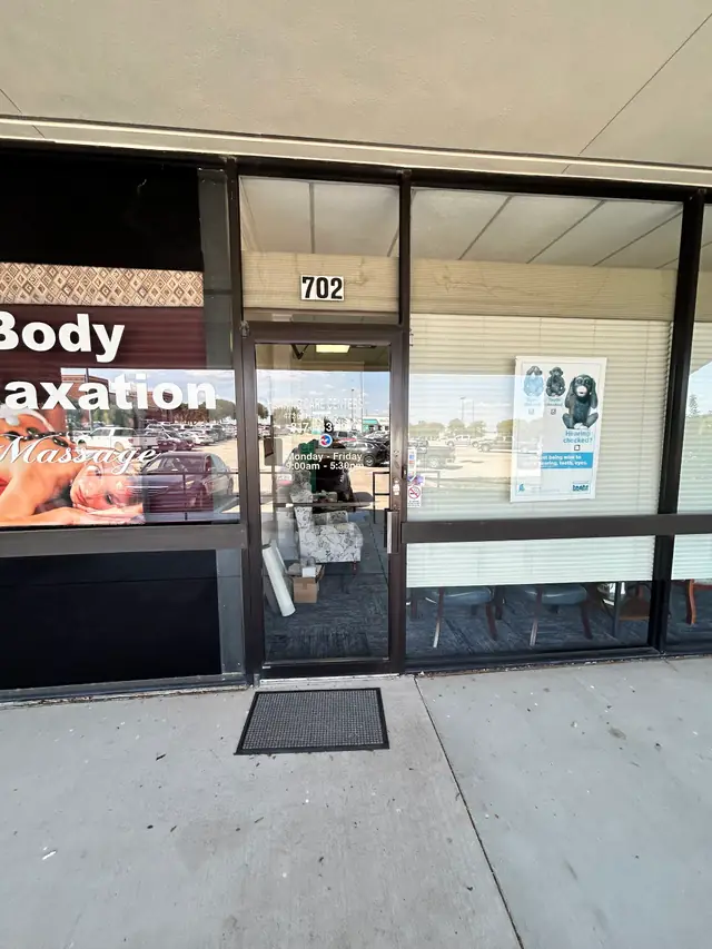 The entrance to Chappell Hearing Care Centers at suite 702, with the posted opening hours on the glass