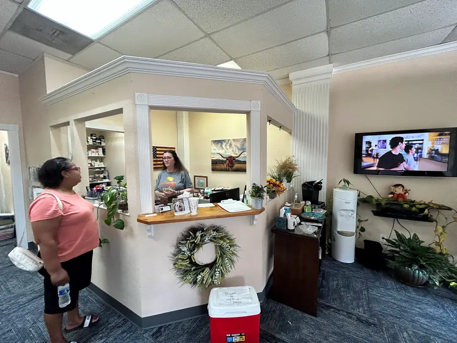 The front desk and reception area at Chappell Hearing Care Centers, with Texas longhorn artwork on the wall